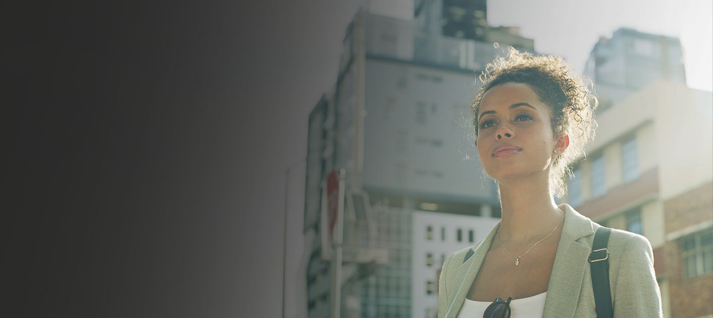 Woman standing in front of  buildings.