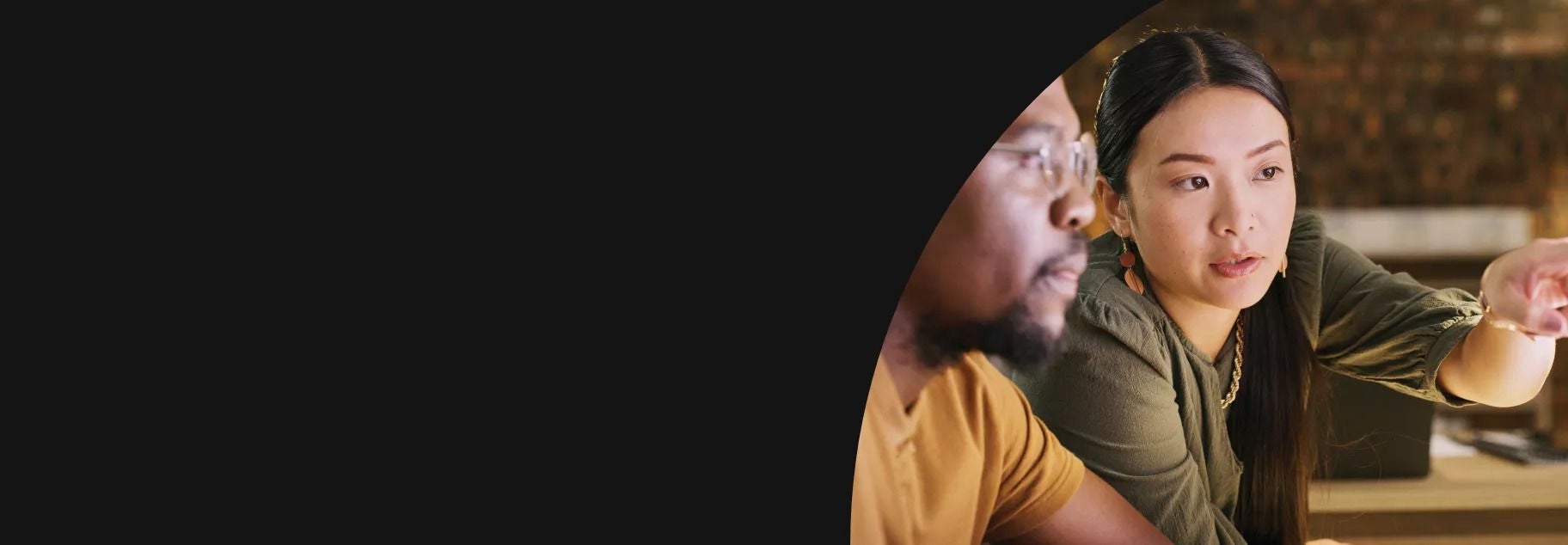 Woman pointing at a screen and the man is looking at it