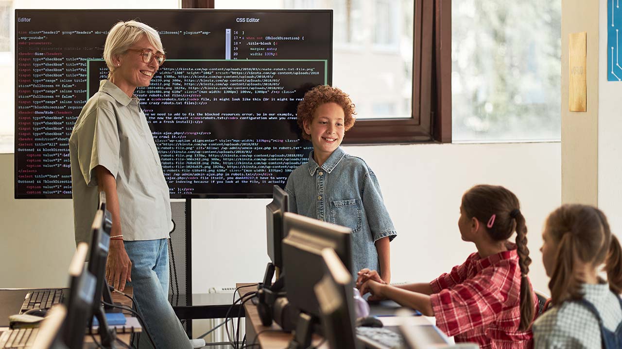 Technology mentorship with kids in classroom.