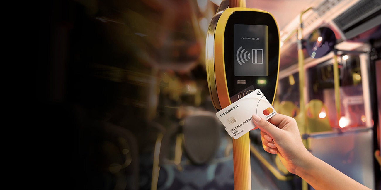 Two smiling people enjoying the benefits of being a Mastercard cardholder.