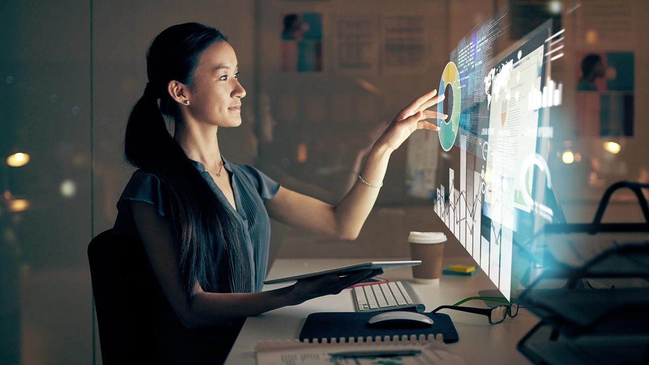 programmer using tablet computer at night in modern office