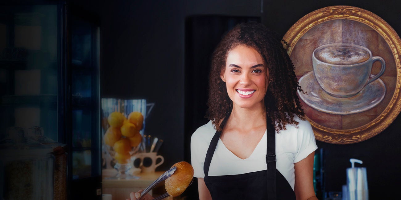 Two smiling people enjoying the benefits of being a Mastercard cardholder.