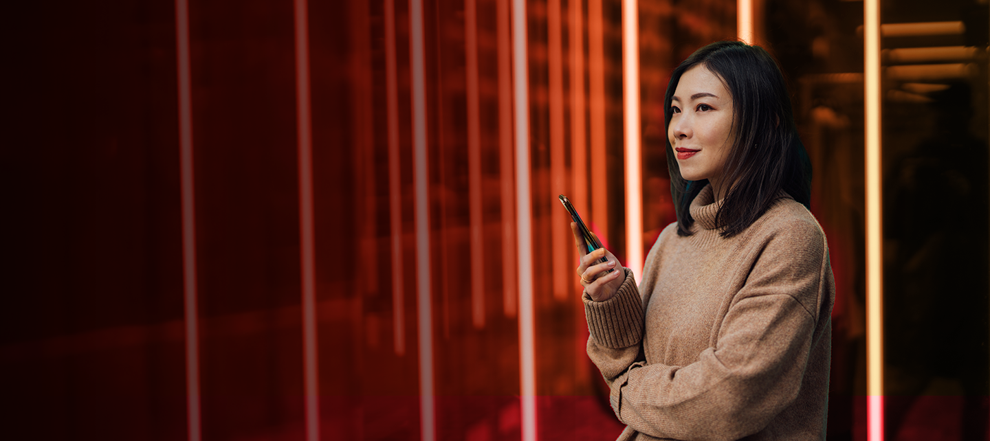 Woman holding a phone at night