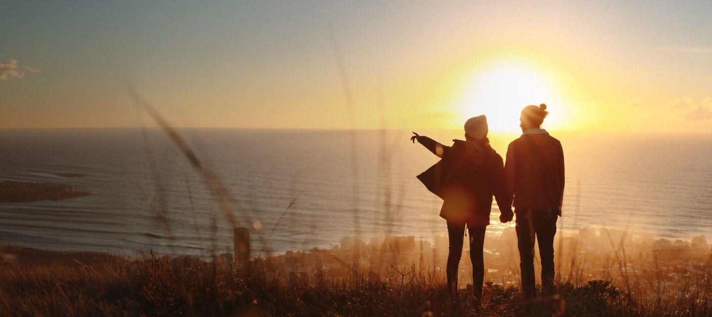 couple watching sunset over the ocean