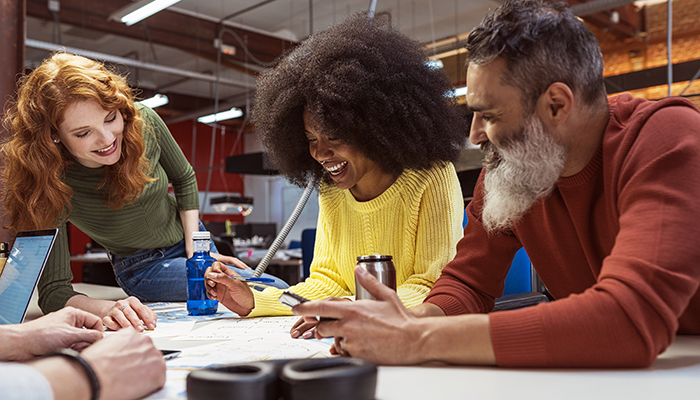 Group of coworkers laughing together in the office