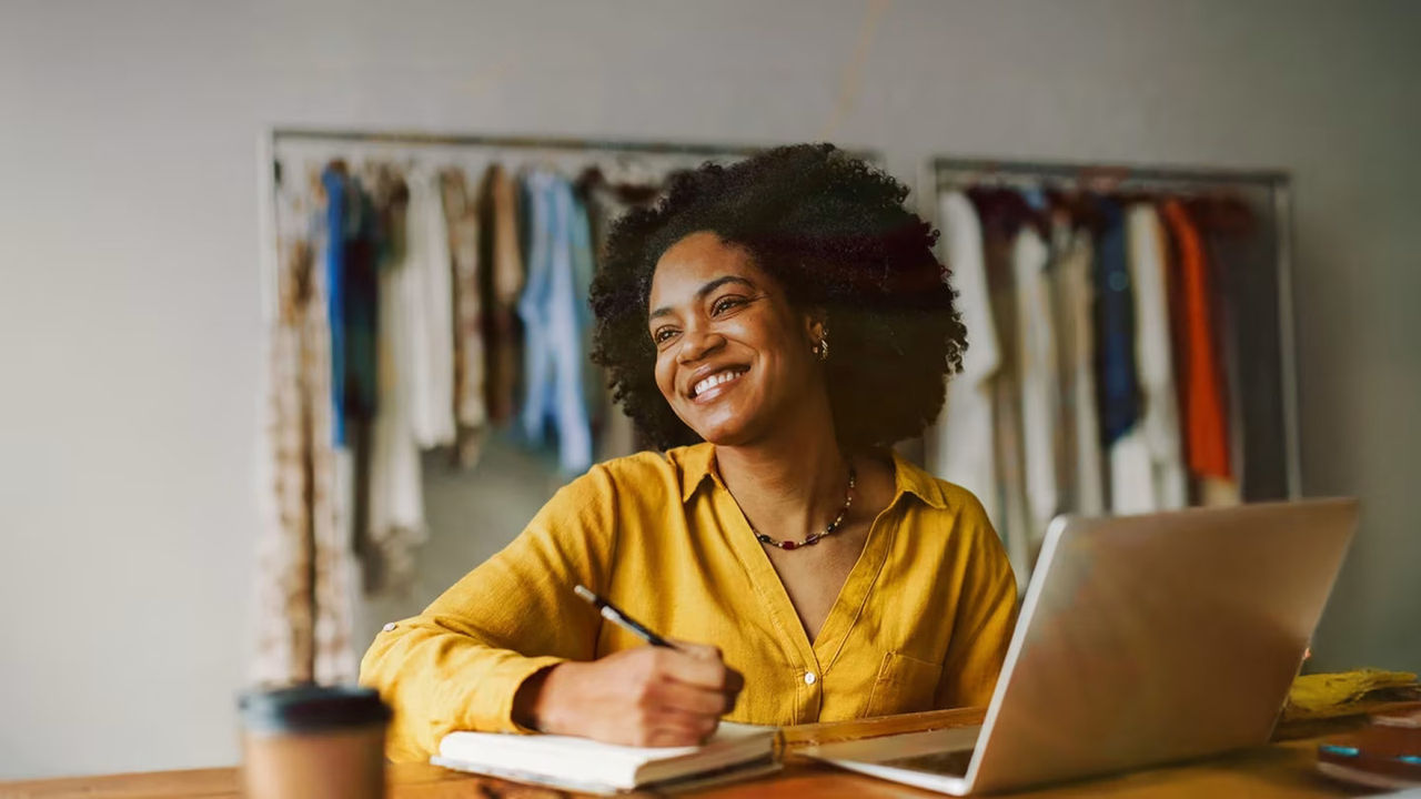 Smiling woman working on laptop