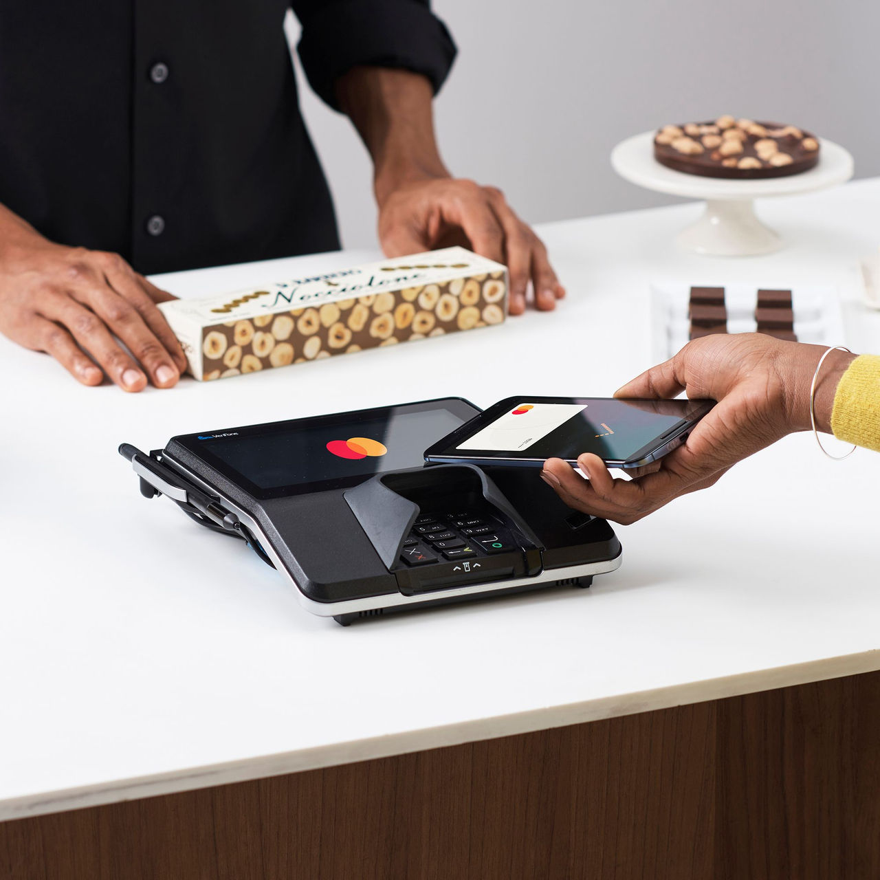 Two people look at a tablet. 