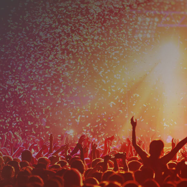 People at a concert as confetti flies over them. 