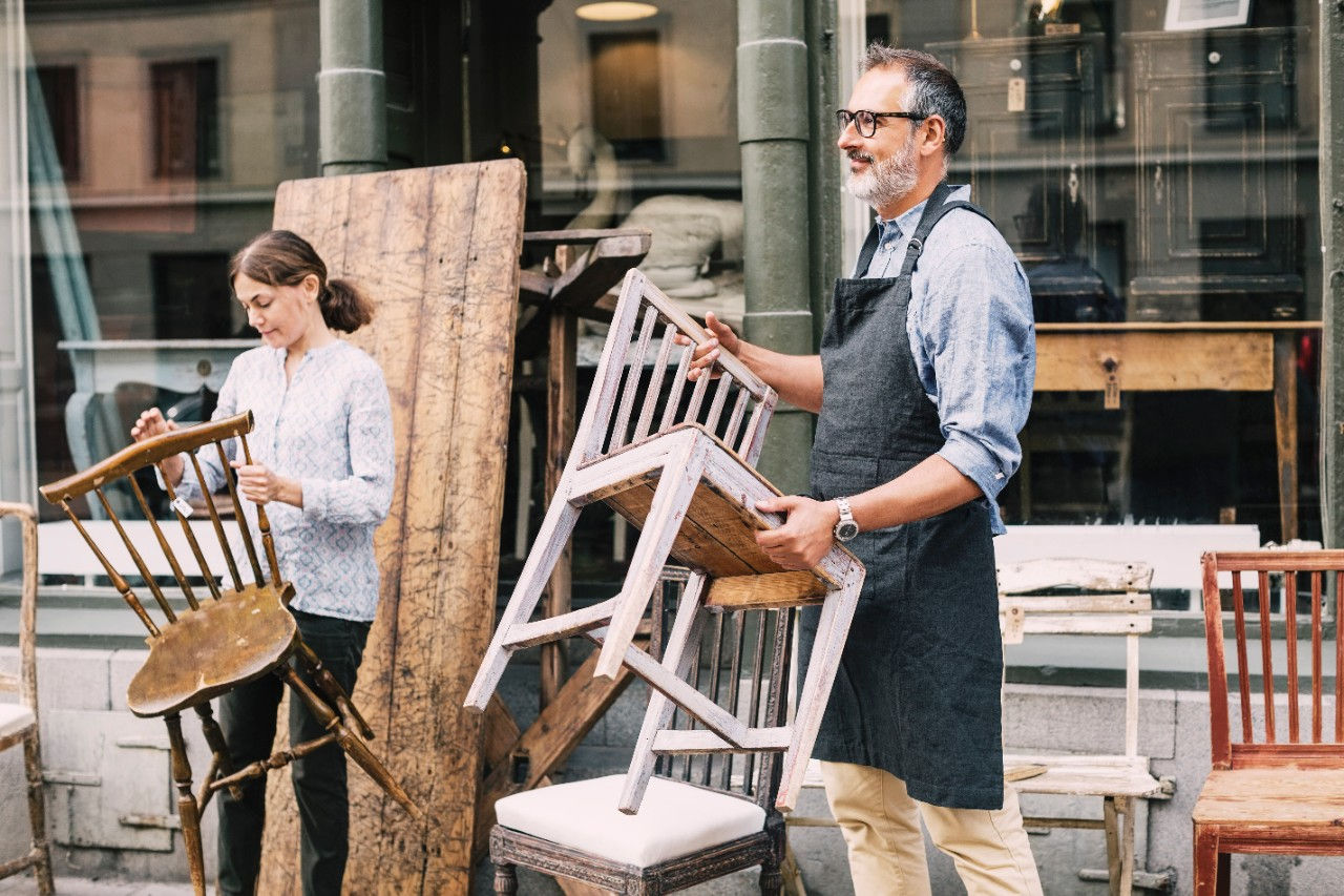 Business owners moving chairs