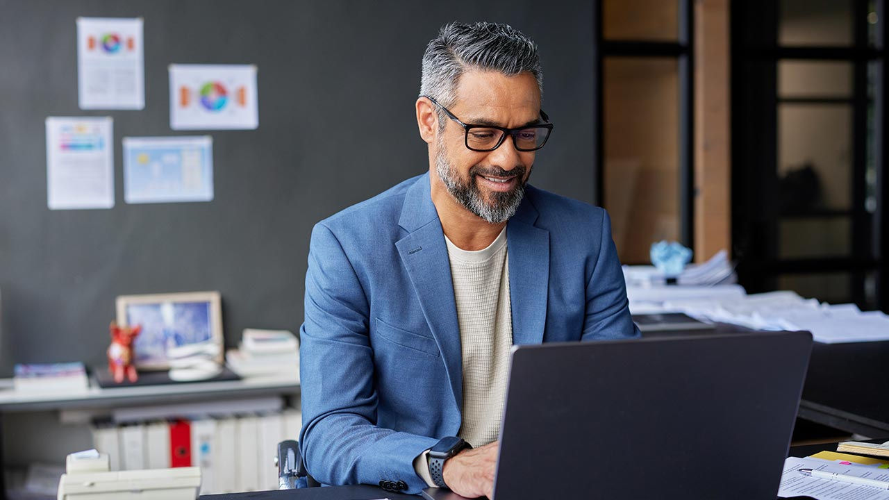 Businessman shopping online in office.