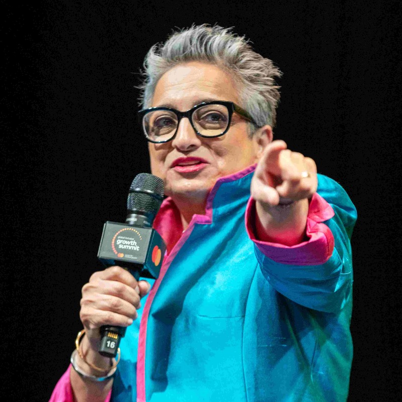 Shamina Singh points to the audience at the summit. 