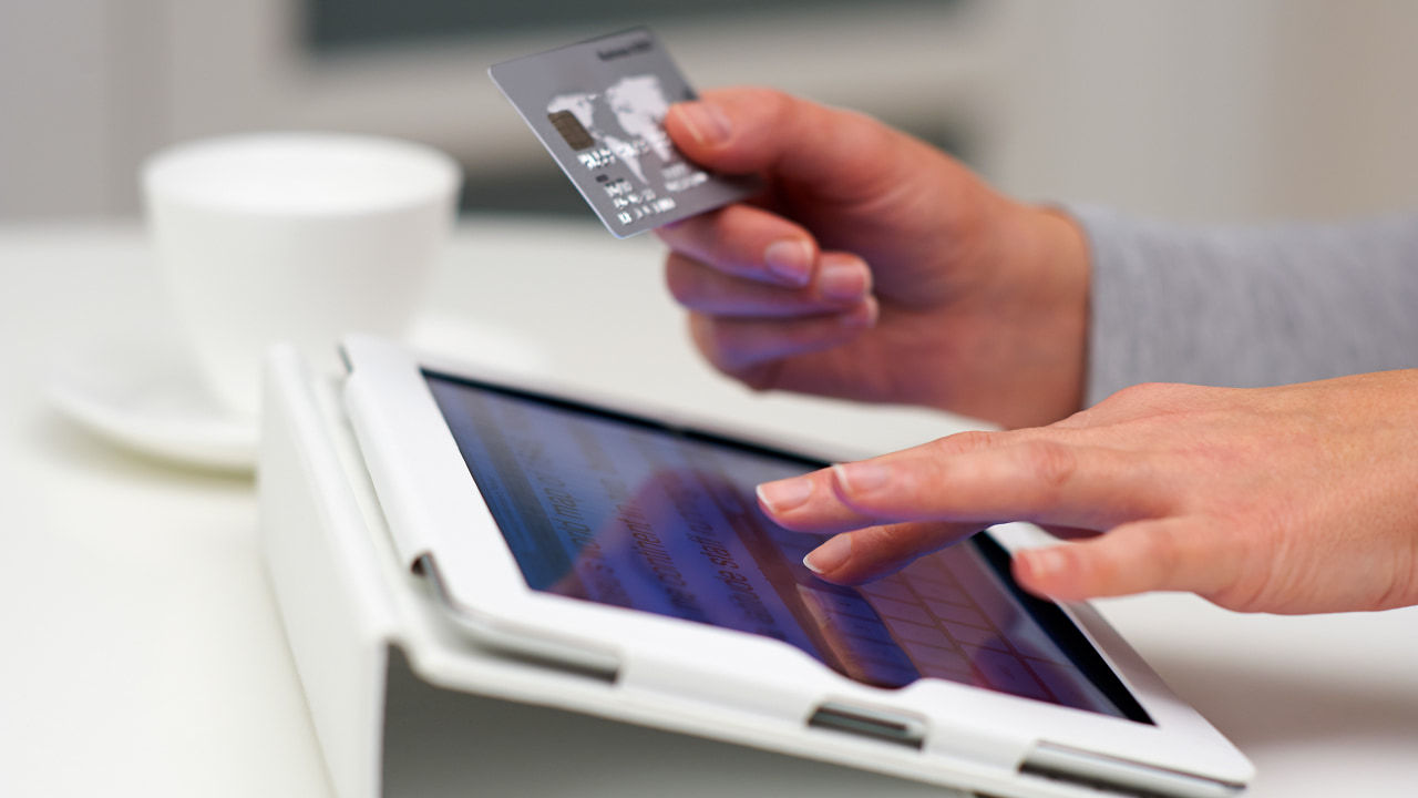 mains utilisant une carte de crédit avec une tablette