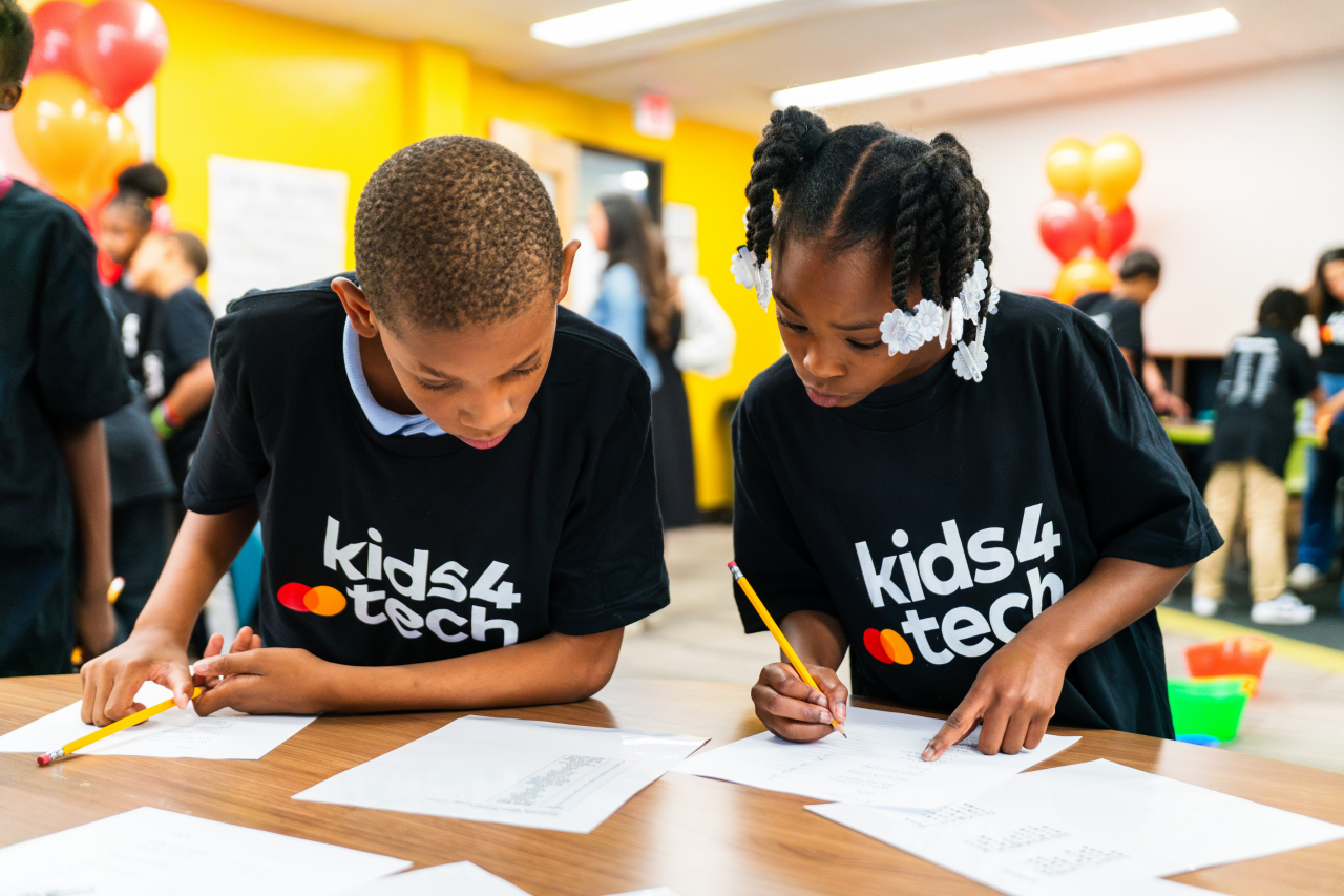 Two children working on a worksheet together.