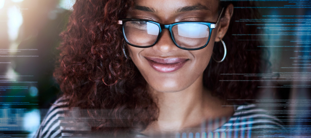 Woman looking at open banking on computer screen smiling