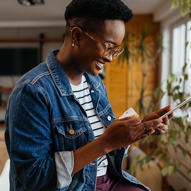 A woman looks at her phone at home. 