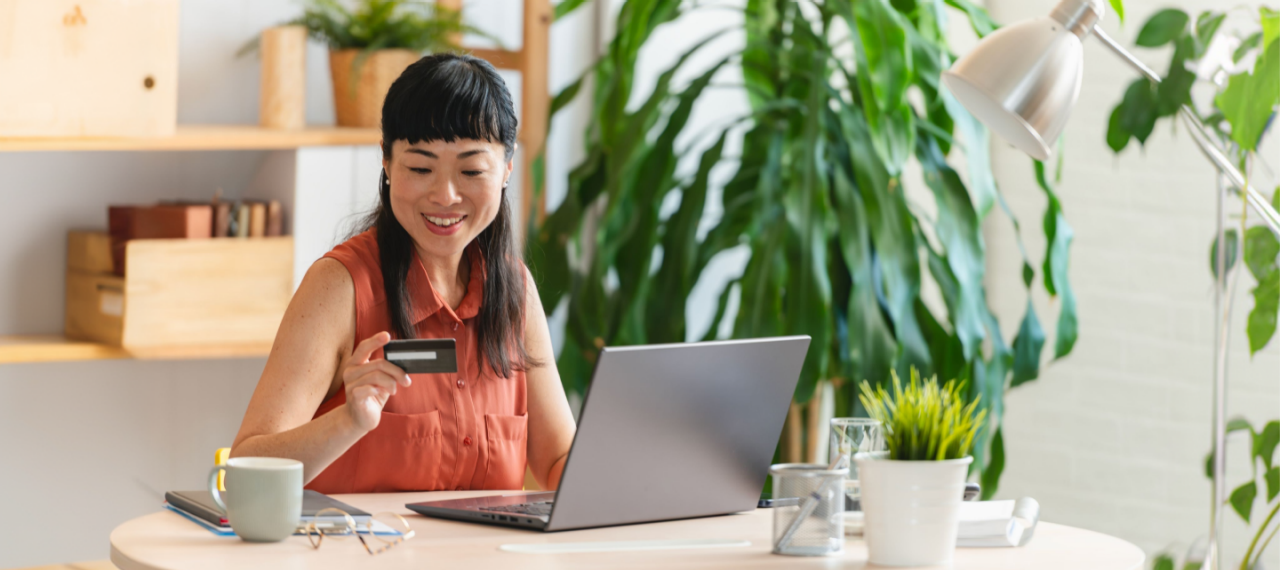Woman making a purchase using her card on her laptop