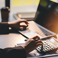 Man using calculator and laptop.