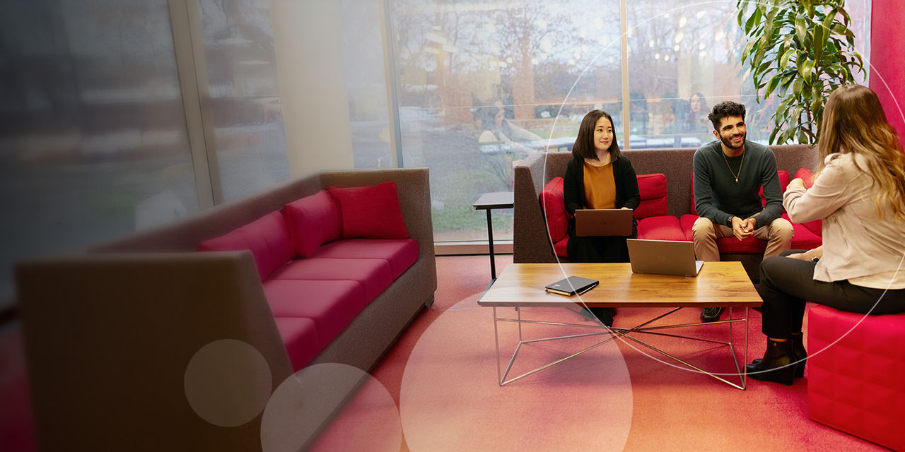 Exployees having a meeting in glass room desktop banner.