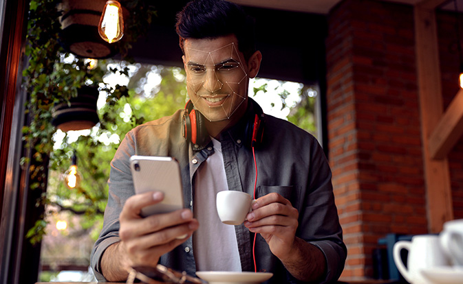 Man consumer holding smartphone typing.