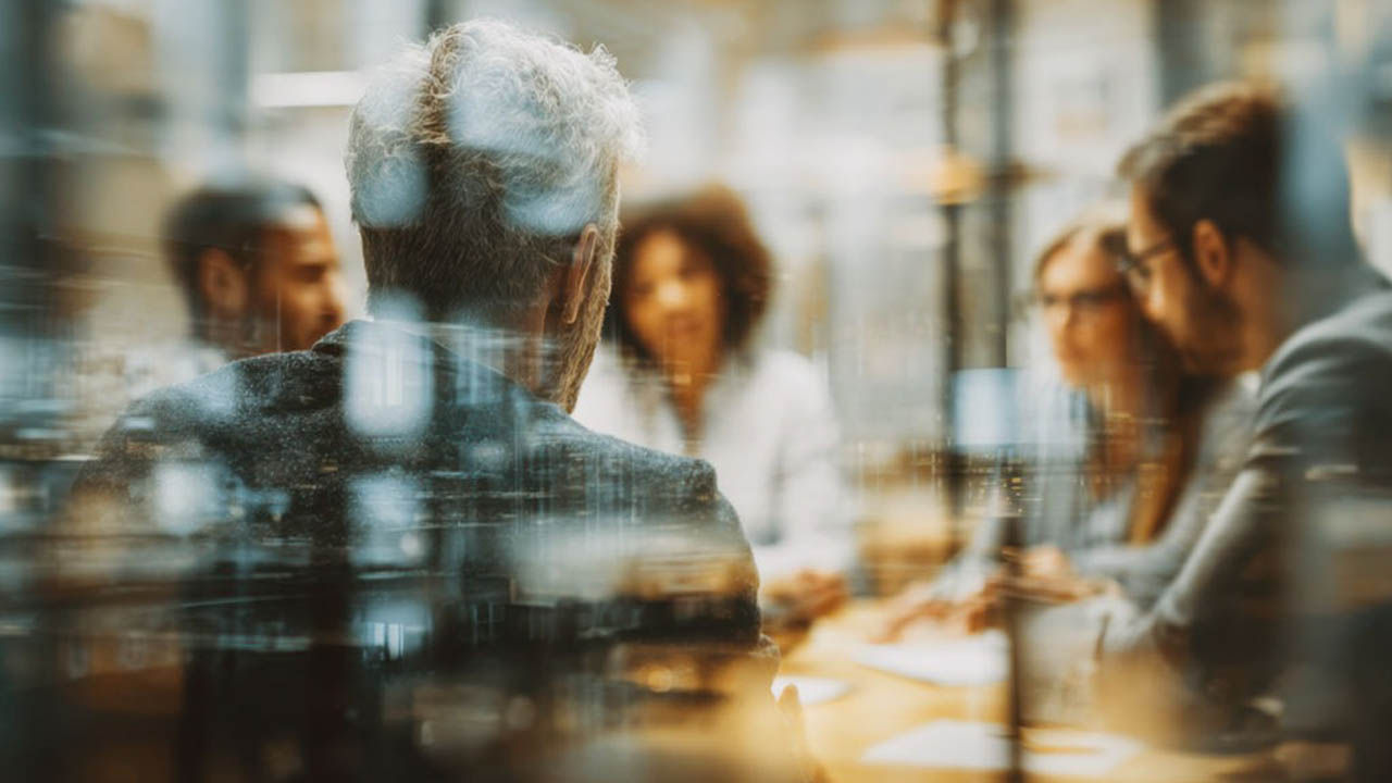 Ein vielfältiges Team, das in einem modernen Büroumfeld zusammenarbeitet und Innovation und strategische Planung für zukünftigen Erfolg fördert, mit Fokus auf Führung.