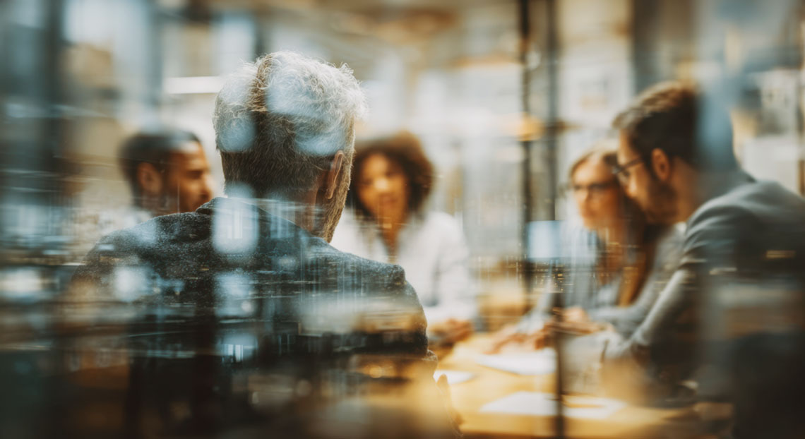 Diverse team collaborating in a modern office setting fostering innovation and strategic planning for future success with a focus on leadership.