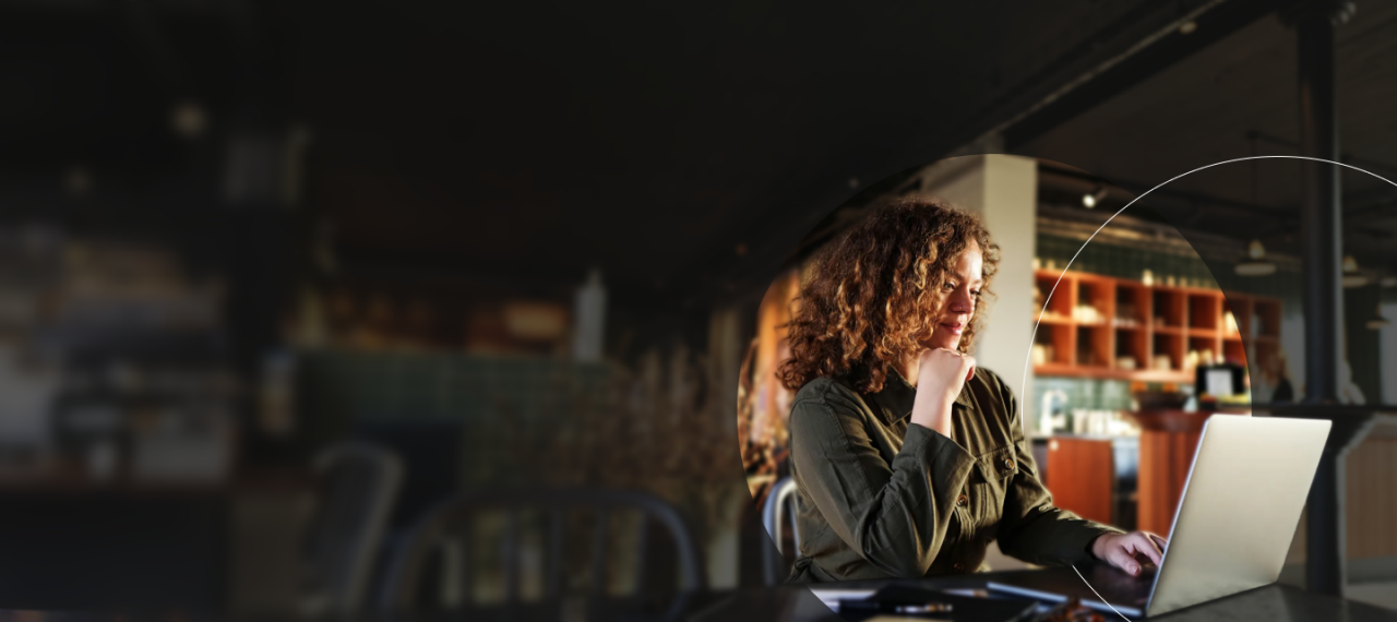 Mujer trabajando en una computadora portátil en una cafetería