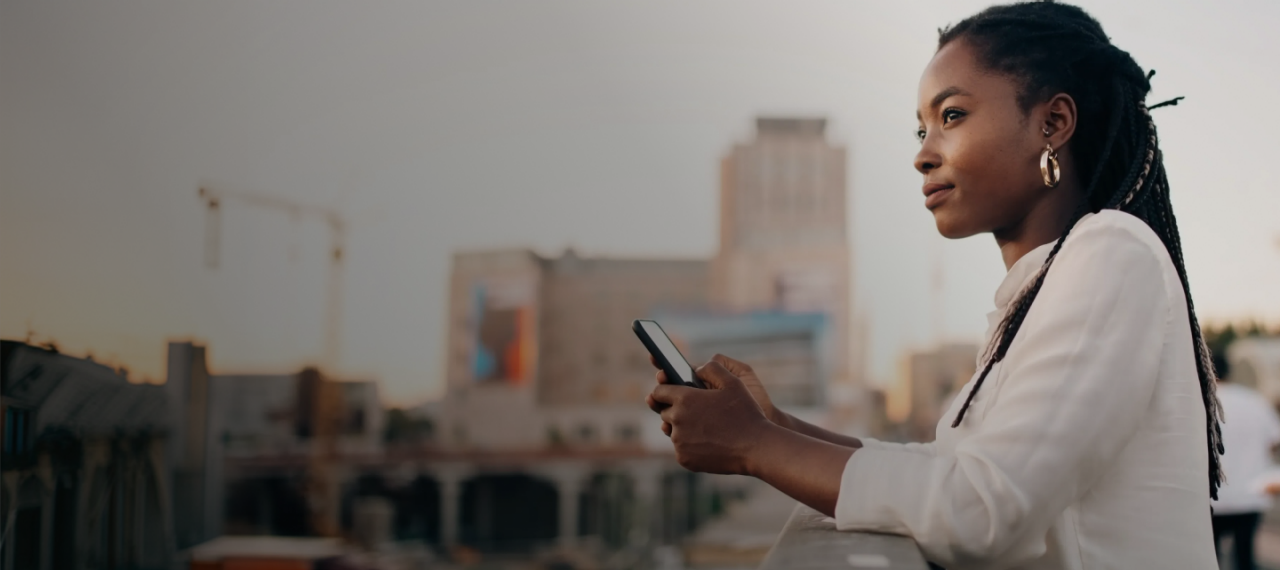 A woman with braids using her phone