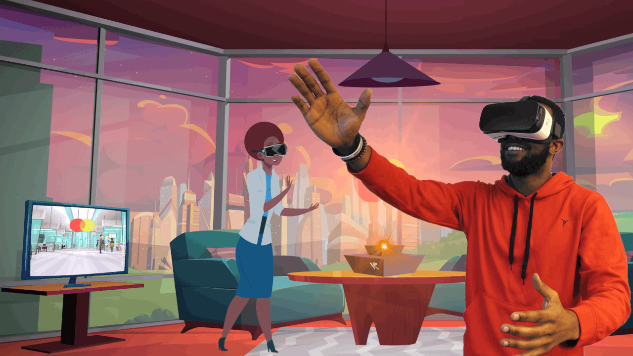 Two people in an office setting wearing virtual reality headsets. One person is standing in front of a windowed wall while another sits on a couch holding out their hand as if interacting with something in VR.