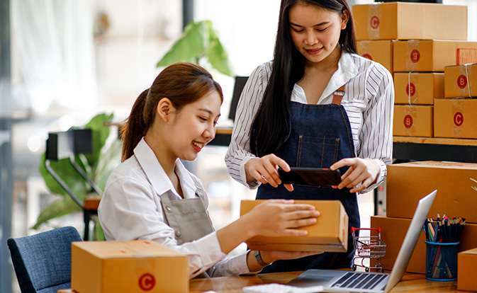 Two women sending packages
