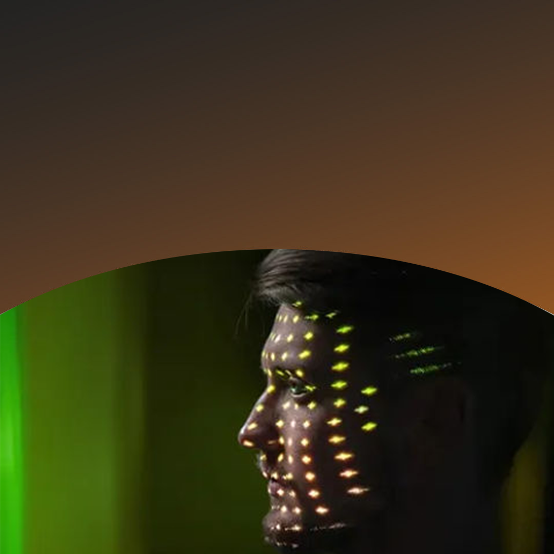 Man staring off with lights over his face