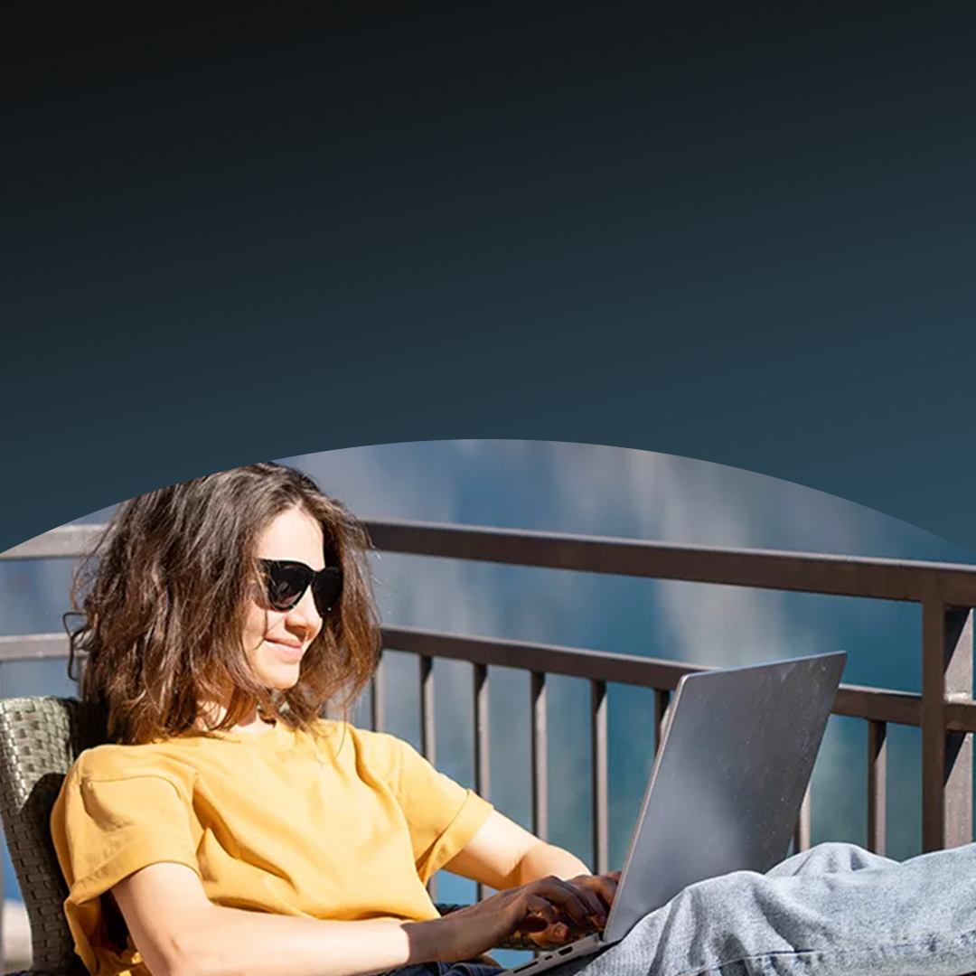 Young woman using laptop outdoors.