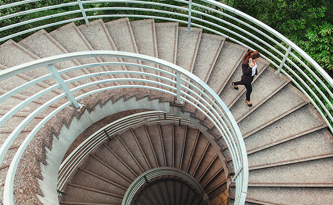 Woman walking down staircase.