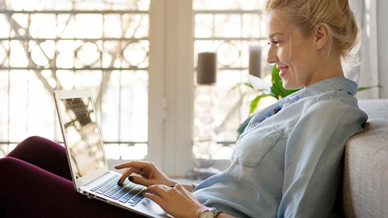 woman working on laptop in the couch