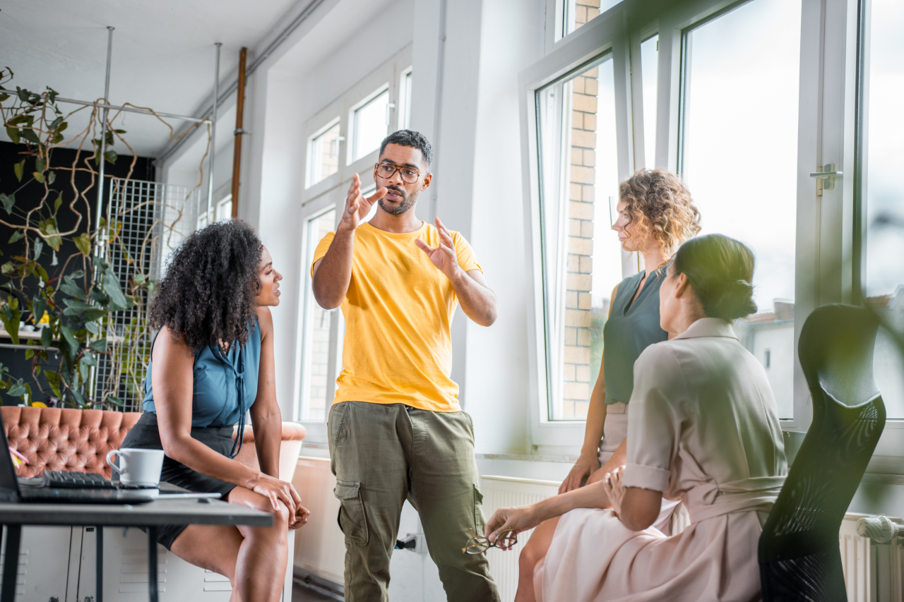Man instructing group of colleagues