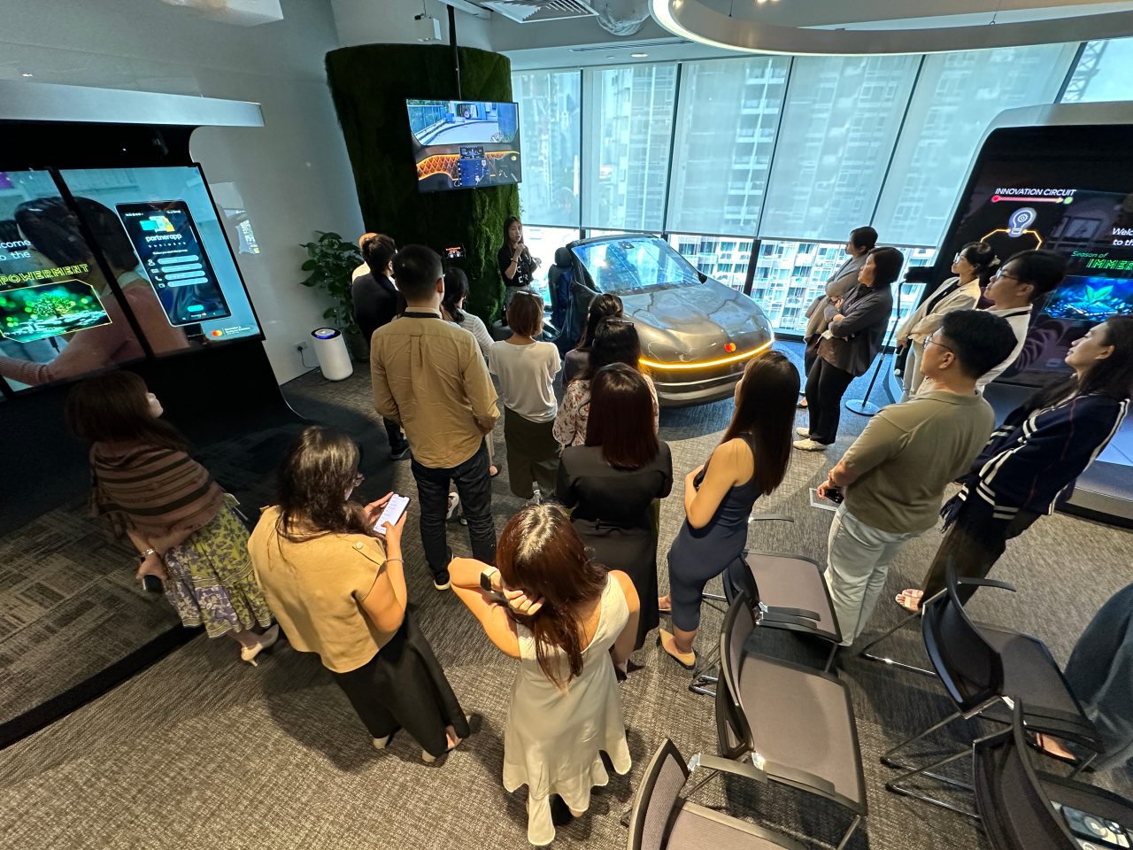 People gathered around concept car at Mastercard Experience Center.