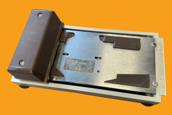 A zip zap machine against an orange background. 