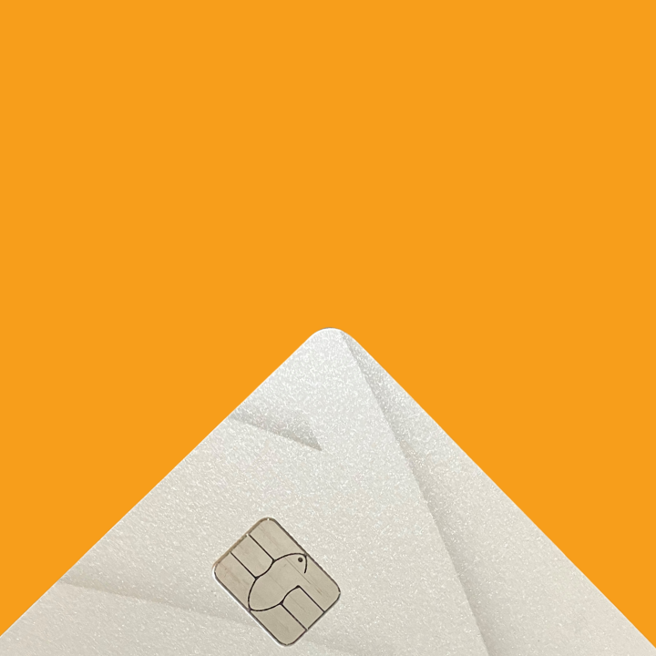 A corner of a payment card showing a chip against an orange background. 