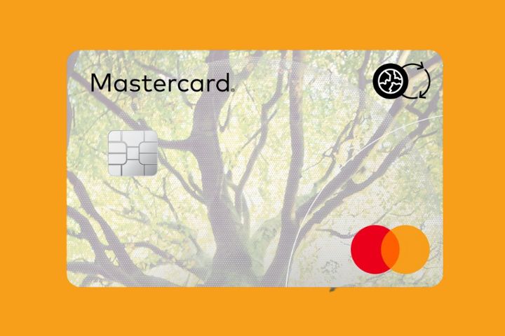 A Mastercard with sustainable badge against an orange background. 
