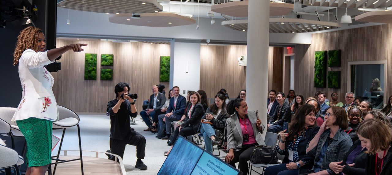  Cassandra Freeman speaks to small business owners , pointing to one of them, at the Mastercard Small Business Summit in New York City. 