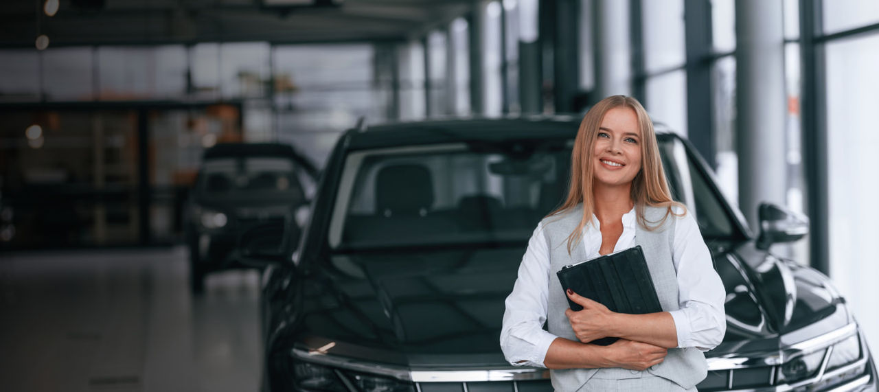 woman in front of a car