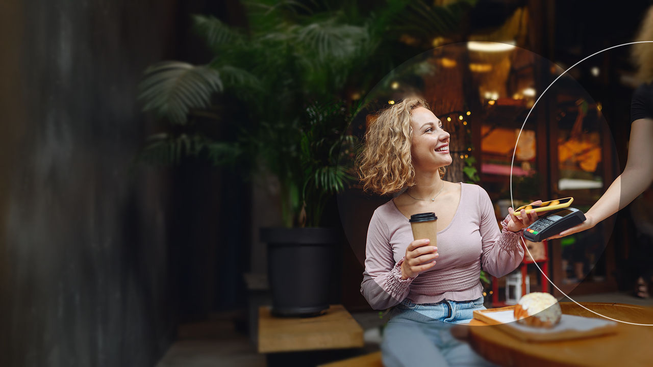 Woman making payment at cafe.