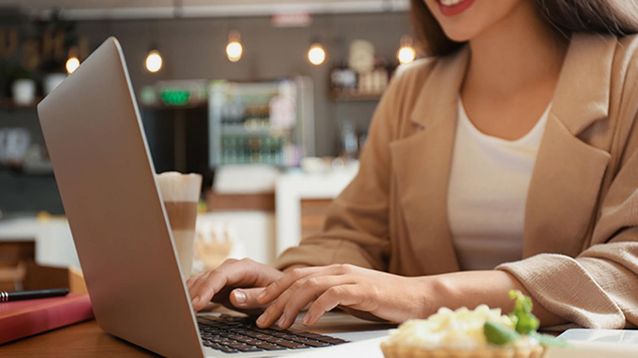 Office worker with laptop in cafe