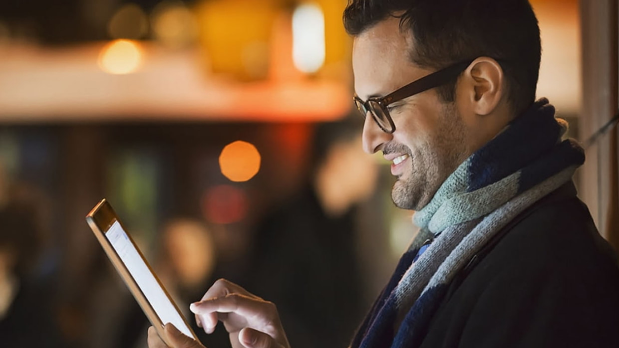 man using tablet night background