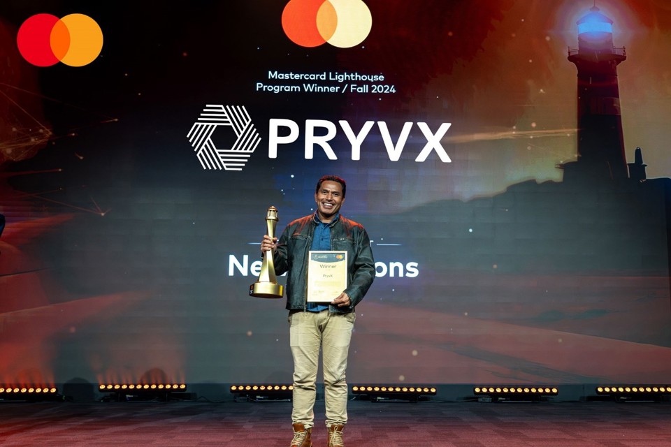 Mastercard lighthouse winner standing on stage with trophy