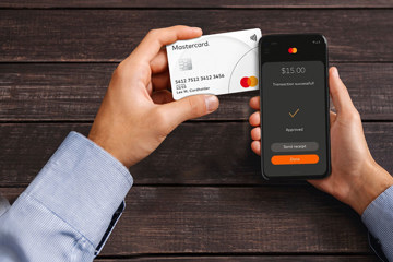 Iphone and credit card held by hands