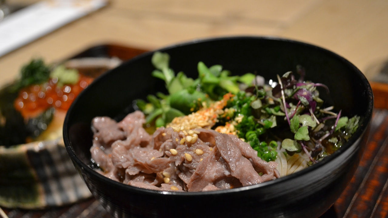 The final savory course features housemade soba topped with A5 wagyu and fresh greens.
