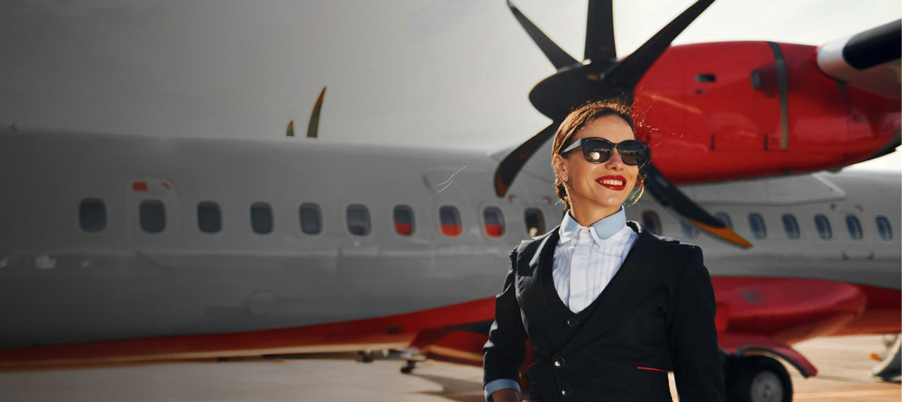 woman standing by private airplane