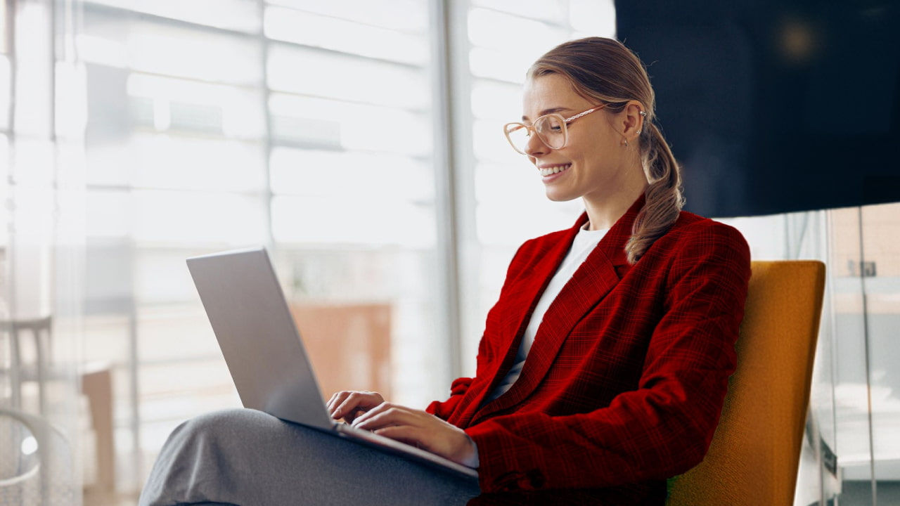 smiling woman working on a laptop