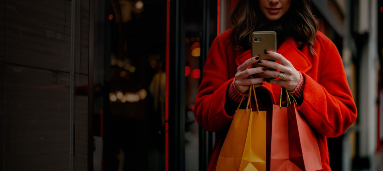 woman holding phone shopping bags
