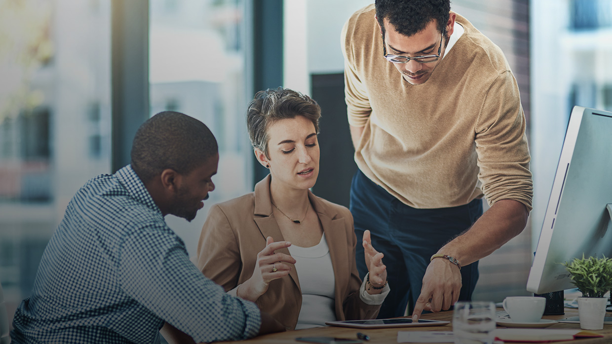 Three people in a conference room discussing Money Movement